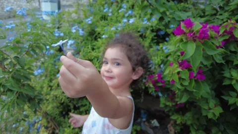 Cute child is playing with flowers. Stock Footage 228764050