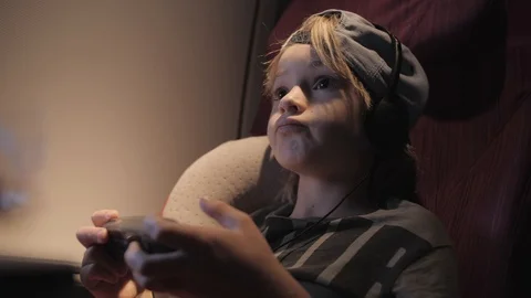Cute child playing games, watching movie traveling by airplane. Stock Footage 103671857