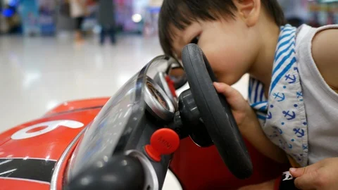 Cute child playing small car in shopping mall department store Stock Footage 109088762