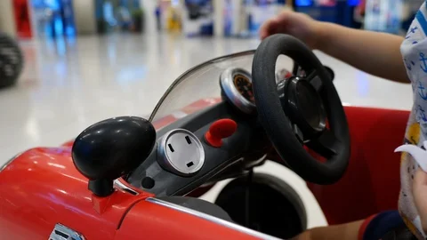 Cute child playing small car in shopping mall department store Stock Footage 113894536