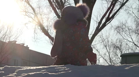 Cute Child Playing in Snow in Winter. Sunny day Stock Footage 60243183