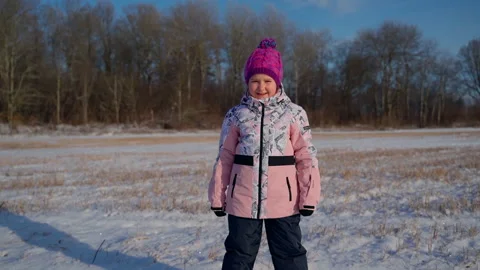 Cute child portrait standing looking at camera at winter outdoors Stock Footage 166585589