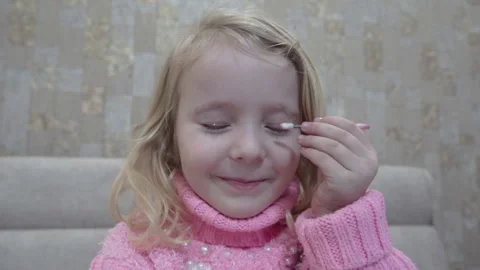Cute Child Pretending to Apply Makeup and Do Mascara Stock Footage 338396412
