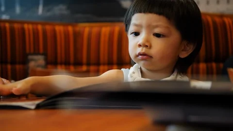 Cute child in restaurant Stock Footage 89798131