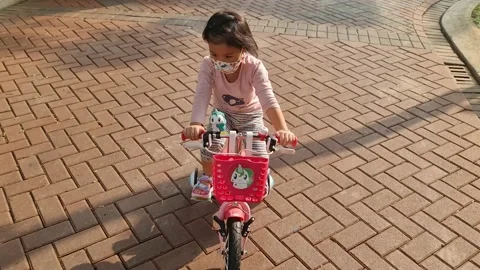 Cute child riding a three wheel bicycle Video stock 159440407