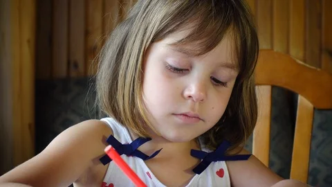 Cute Child sits at the table and draws with pencils. Video stock 102303452
