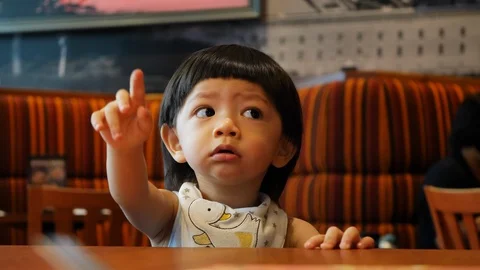Cute child sitting in restaurant Stock Footage 93483033