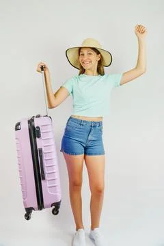 Cute child in a straw hat is happy to go on summer vacation. Travel and vac.. Stock Photos