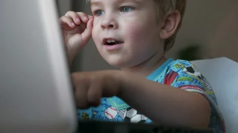 Cute Child Study Online Clever Boy Learning Laptop Computer Distance Education Video stock 137441573