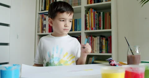Cute child thinking about drawing at school. Stock Footage 130753010