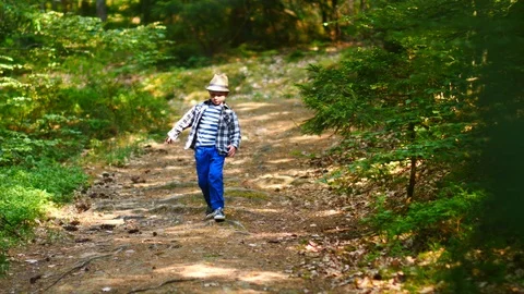 Cute Child Walking Alone In Green Forest 스톡 동영상 89632136