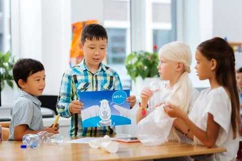 Cute children discussing ecological problems at school Stock Photos