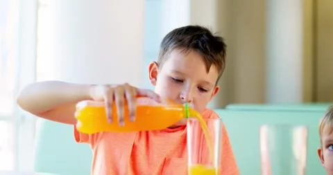 Cute children drinking soda or soft drink with straw in a fast food restaurant Stock Footage 252298802