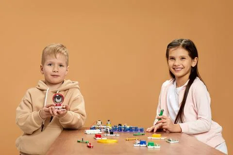 Cute children playing with electronic constructor at studio Stock Photos