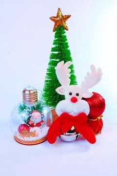Cute Christmas background featuring a soft reindeer toy and miniature Christmas Stock Photos