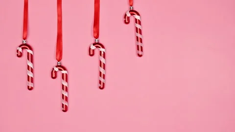 Cute Christmas background with hanging candy canes on ribbon. Stop motion Stock Footage 229507261