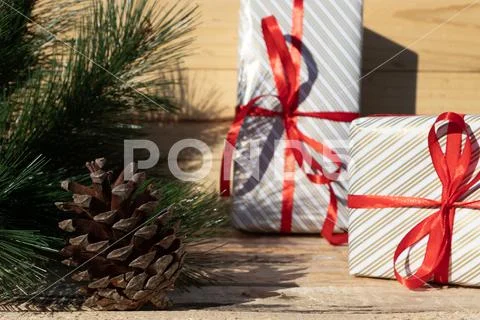 Cute christmas gifts with red ribbon near christmas tree Stock Photos