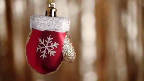 Cute Christmas tree bauble in form red Santa Claus mitten with snowflake closeup Stock Footage 258456860