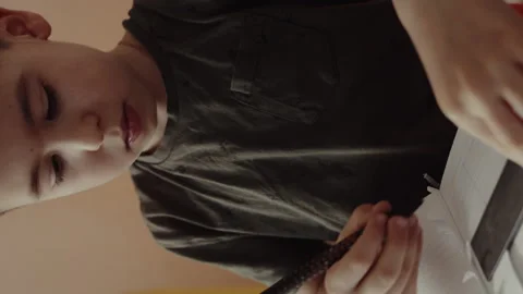 Cute concentrated boy making a drawing with a ruler and pencil. The concept of Stock Footage 258163642