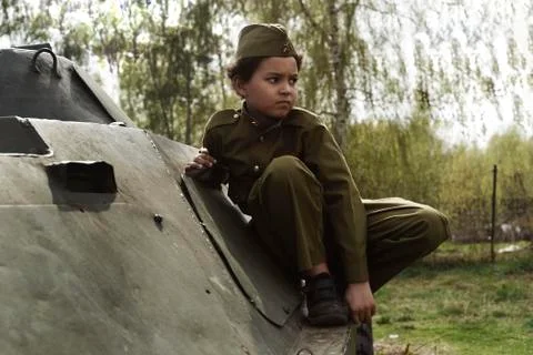 Cute cool boy in costume of the Second World War time sitting in the tank Stock Photos
