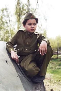 Cute cool boy in costume of the Second World War time sitting in the tank Stock Photos