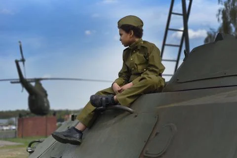 Cute cool boy in costume of the Second World War time sitting in the tank Stock Photos