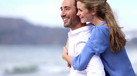 Cute couple on beach looking at ocean Stock Footage 41969517