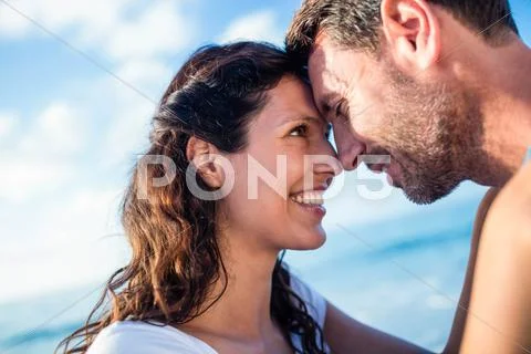 Cute Couple Doing Eskimo Kiss On The Beach
