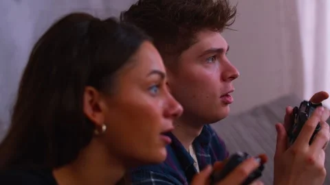 Cute couple gaming together getting intense in close up Stock Footage 292101723