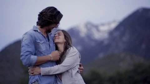 Cute Couple Hold Each Other Close And Chat/Kiss In The Mountains Stock Footage