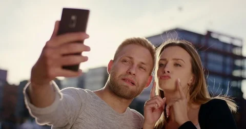 Cute couple making funny things and faces for selfie Video stock 79396009