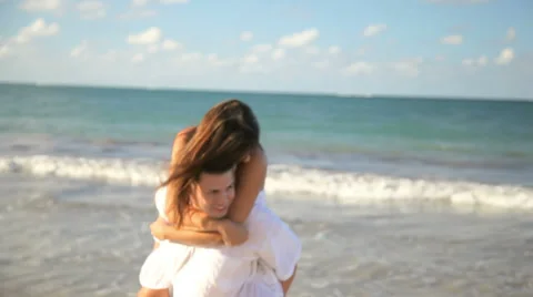 A cute couple play at the beach Video stock 33888579