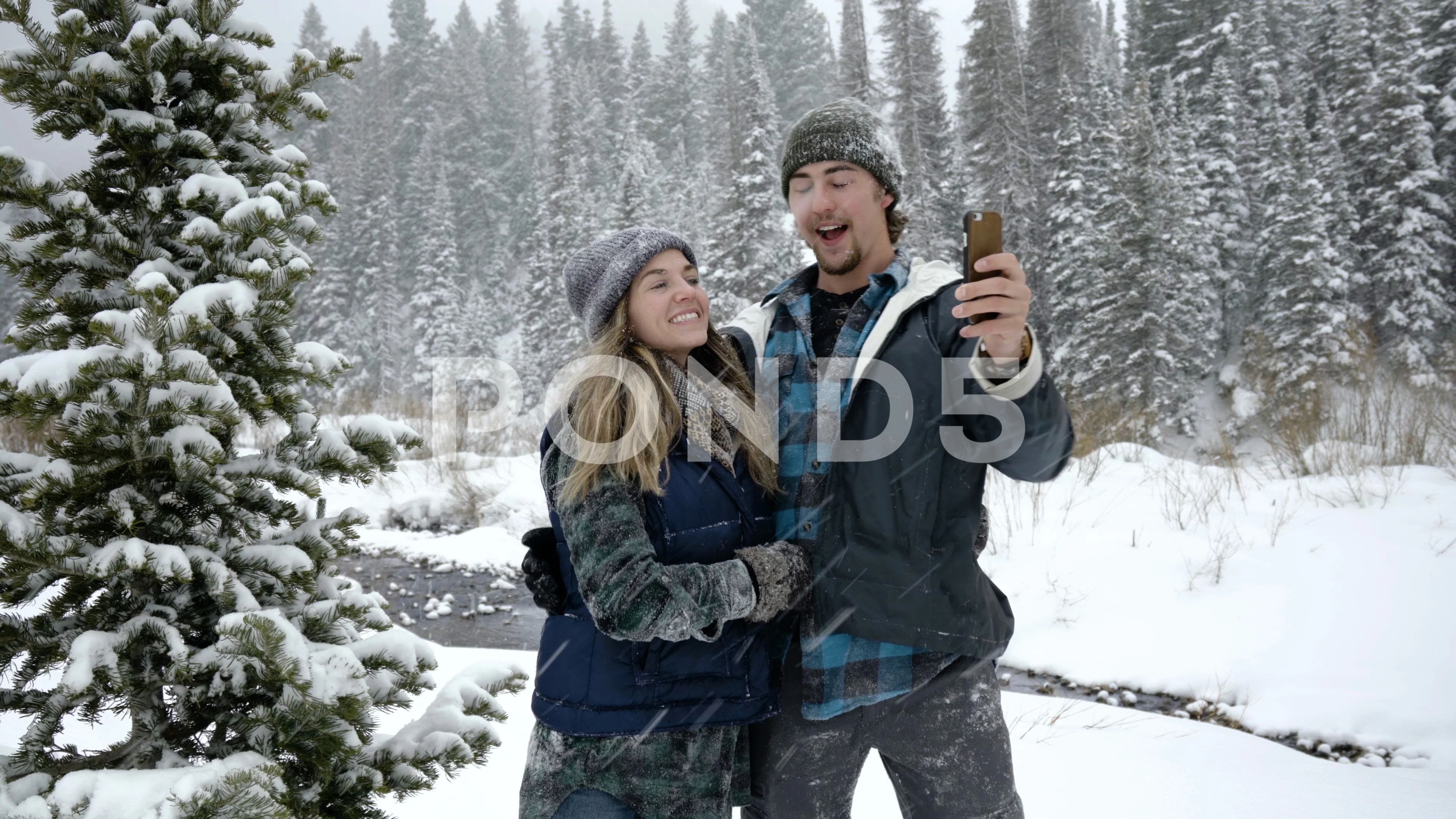 Premium Photo | A young loving couple on a walk in a snow park