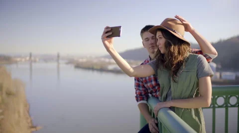 Cute Couple Pose For Selfies On The St Johns Bridge (In Portland, Oregon) Stock-Footage 60995174