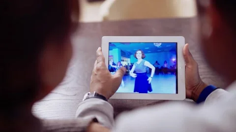 Cute couple relaxing on couch with tablet pc at home in the living room Stock Footage 56589267