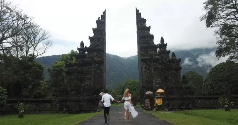 Cute Couple Run Through Bali Gates Stock Footage 106236680