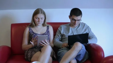 Cute couple is spending time together at the home with gadget Stock Footage 65051080