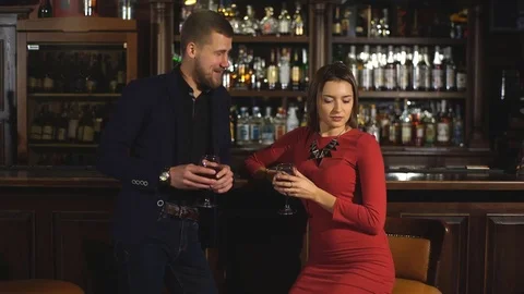 Cute couple talking and having a drink in a bar Stock Footage 70391498