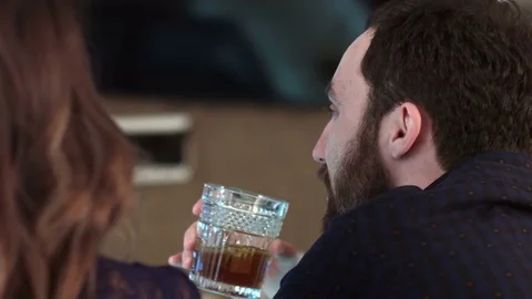 Cute couple talking and having a drink in a bar Vídeos de archivo 76597068