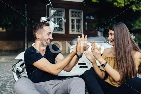 Cute couple with their scooter have fun Stock Photos