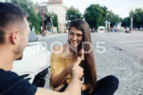 Cute couple with their scooter have fun Stock Photos