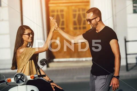 Cute couple with their scooter Stock Photos