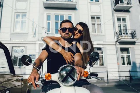 Cute couple with their scooter Stock Photos