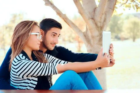 Cute Couple Using PC Tablet Outdoors in Nature Stock Photos