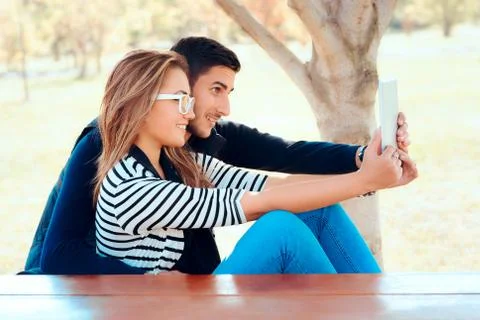 Cute Couple Using PC Tablet Outdoors in Nature Stock Photos
