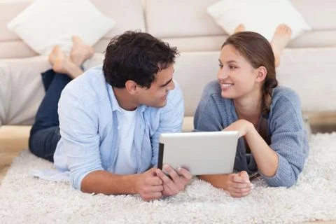Cute couple using a tablet computer Stock Photos