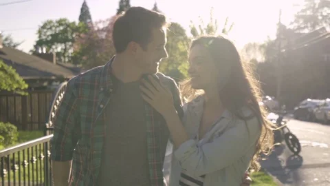 Cute Couple Walk Down Sidewalk In Beautiful Neighborhood On A Sunny Day Vidéo 75944803