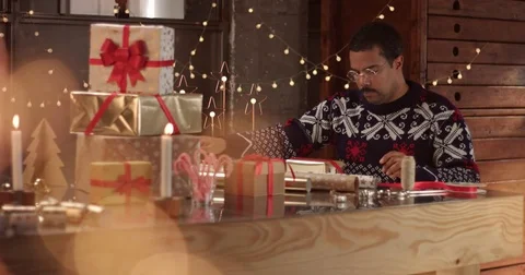 Cute couple in winter sweaters wrapping Christmas presents Video stock 81916408