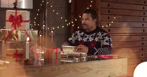 Cute couple in winter sweaters wrapping Christmas presents Stock Footage 81916412