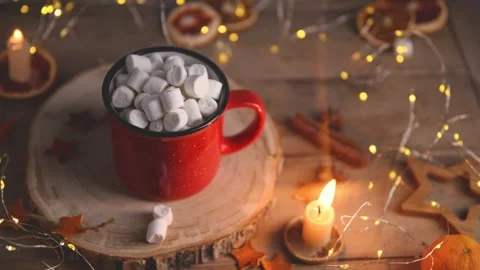Cute cozy winter composition. red mug, marshmallows, oranges and candle. Stock Footage 259045989